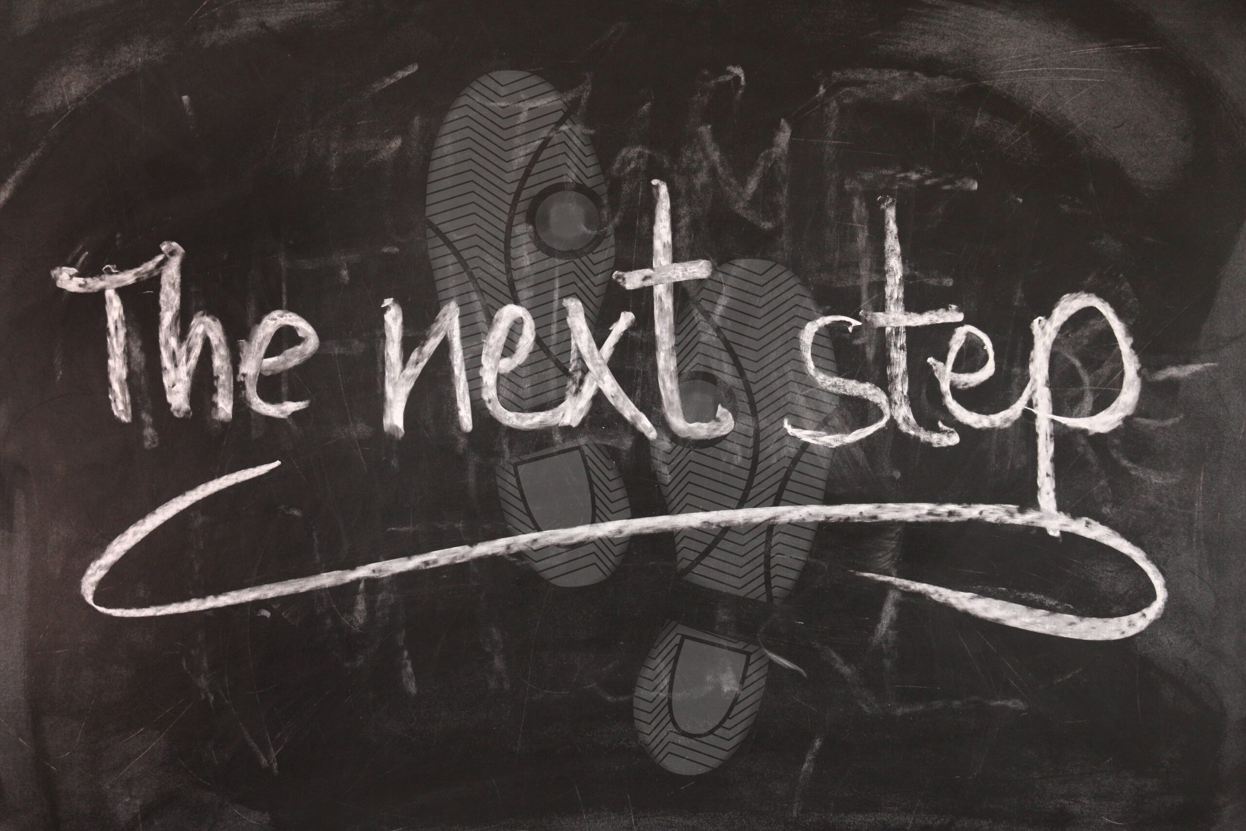 blackboard that reads 'the next step'